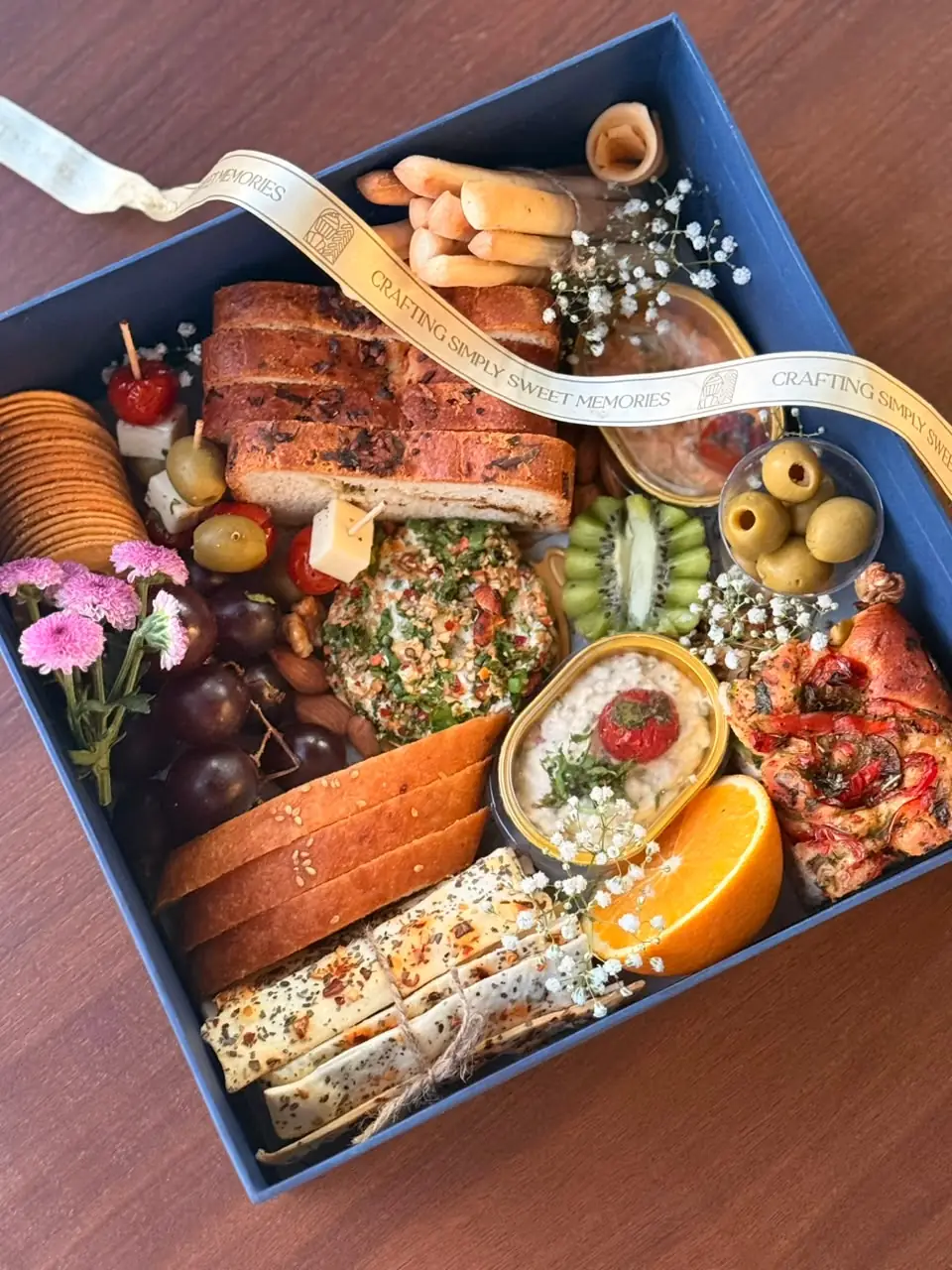 Artisan vegetarian grazing box with focaccia, breadsticks, lavash, dips, olives and fresh fruit by Simply Sweet Udaipur