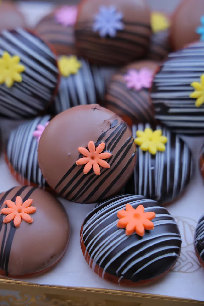 Chocolate dipped donuts with sugar flowers by Simply Sweet Udaipur