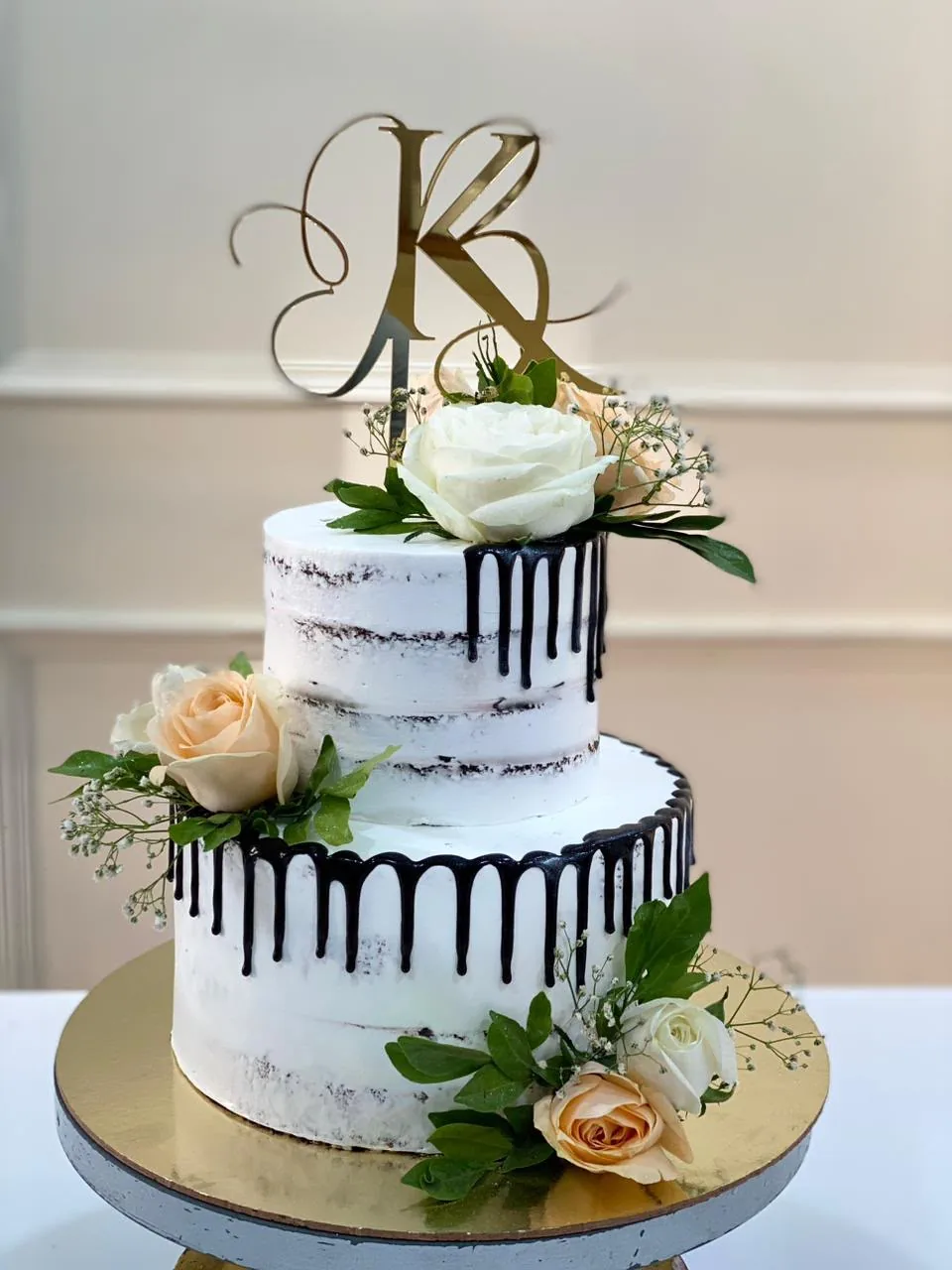 Eggless semi-naked cake with chocolate drip and fresh roses by Simply Sweet Udaipur