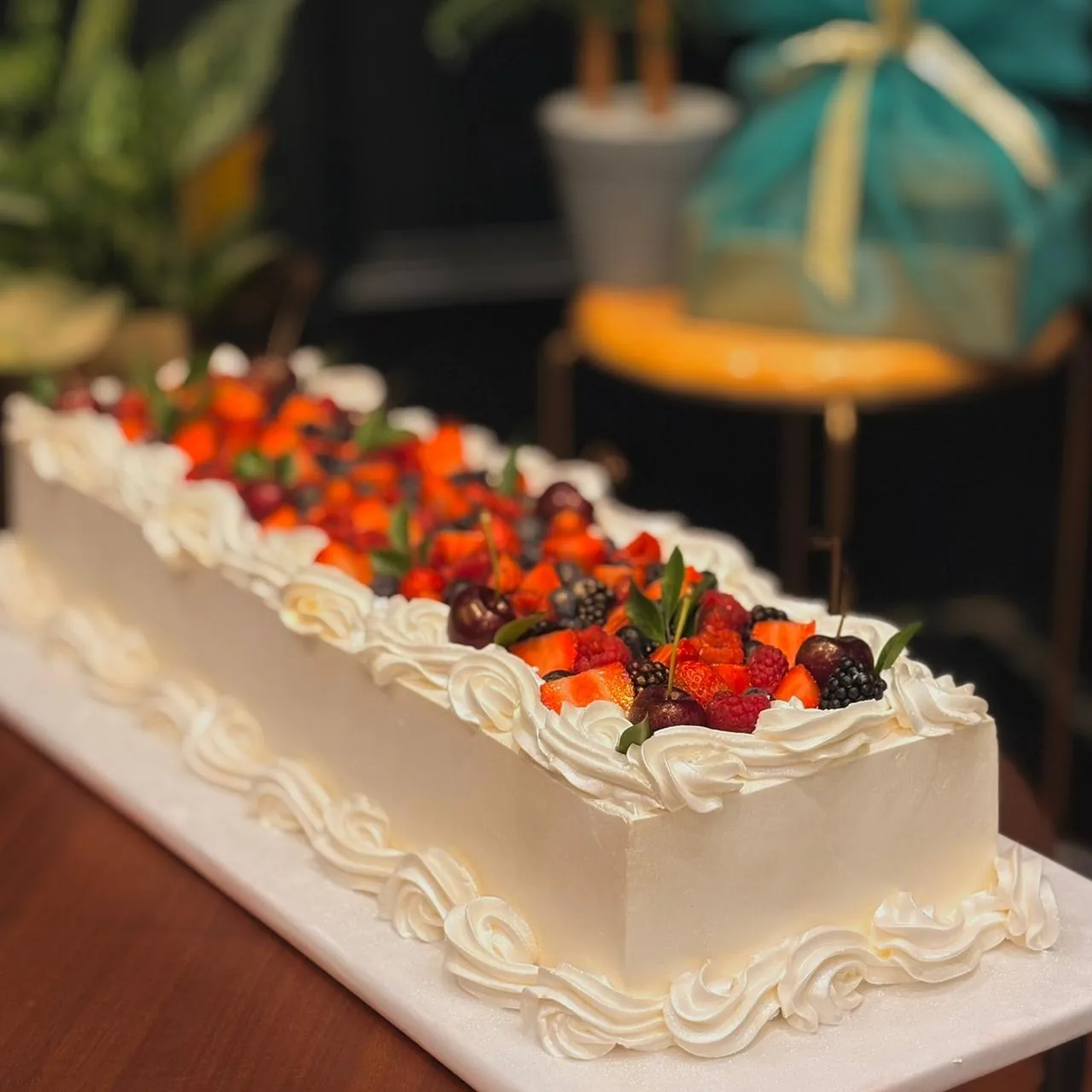 Fresh fruit wedding cake with berries and whipped cream by Simply Sweet Udaipur