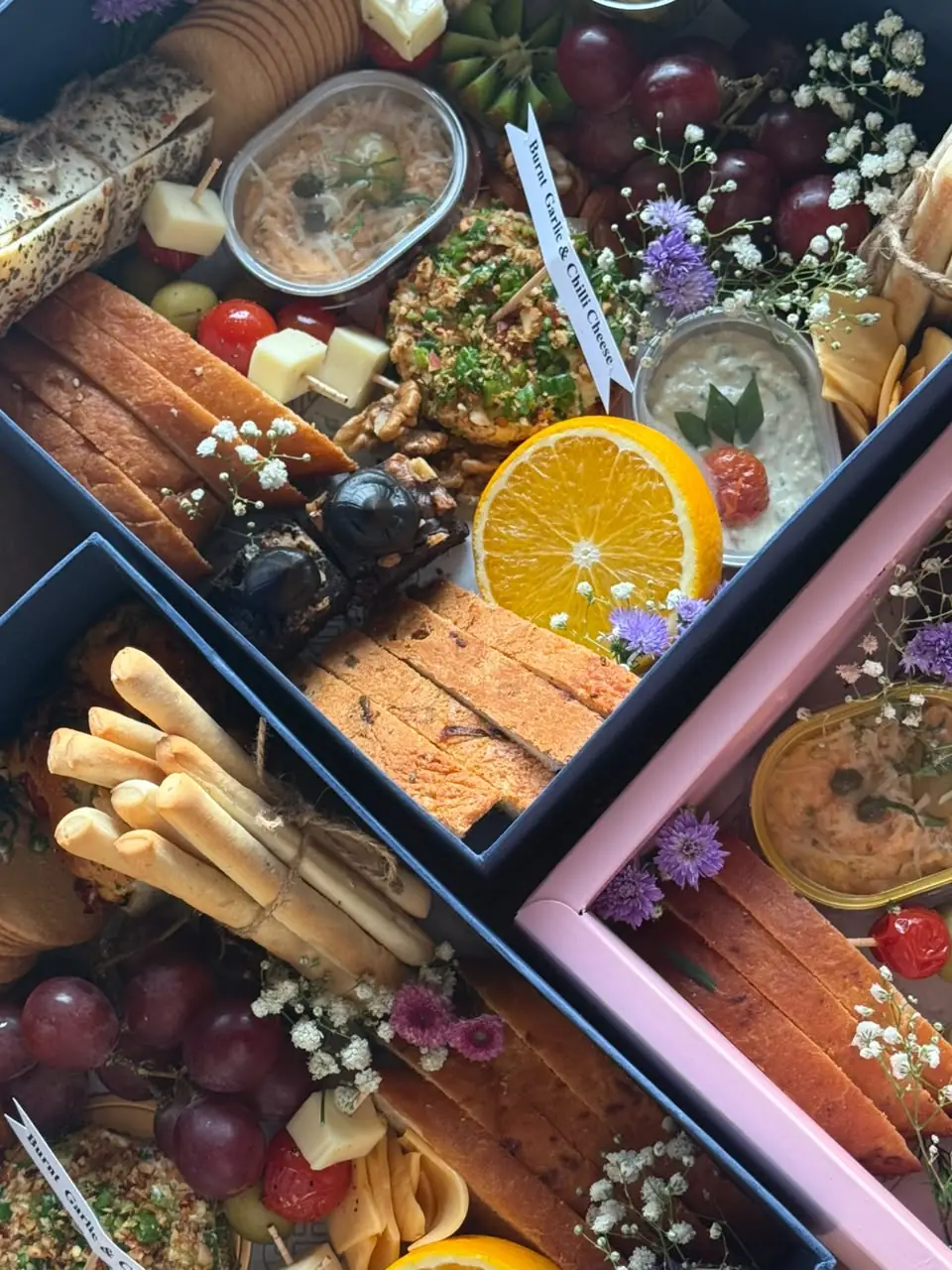 Several vegetarian grazing boxes for a house party by Simply Sweet Udaipur