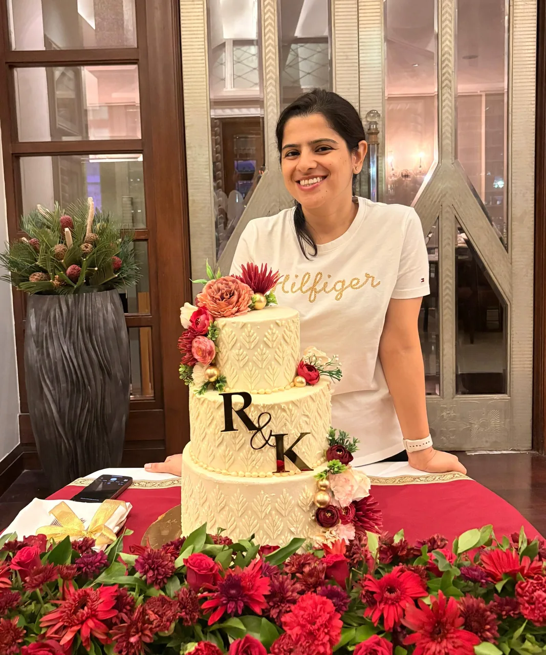 Diya Chhabra with a personalised R&K monogram couple's cake by Simply Sweet Udaipur