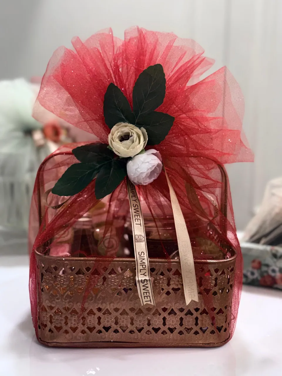 Red tulle wrapped gift basket by Simply Sweet Udaipur