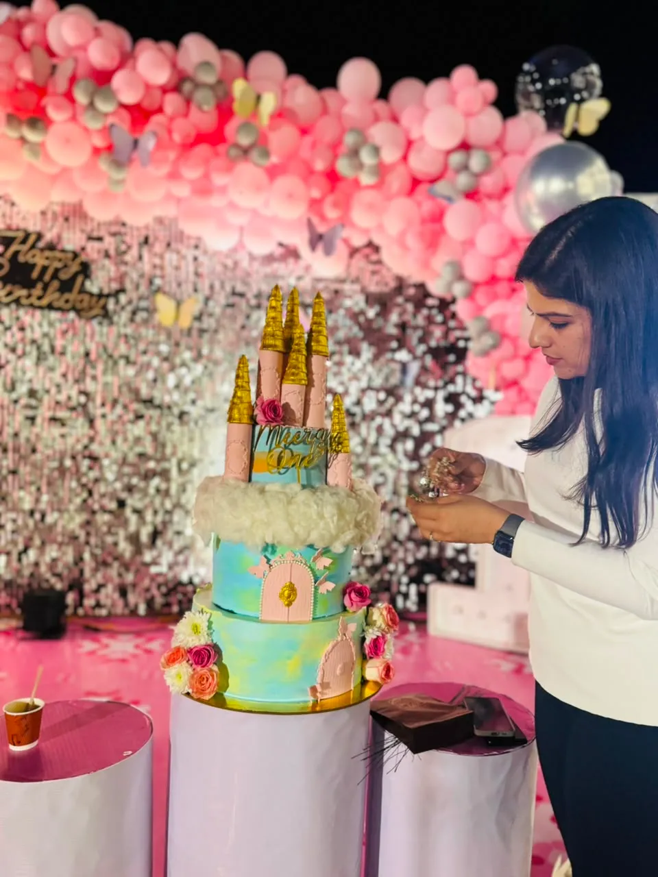 Elaborate castle theme birthday cake by Simply Sweet Udaipur, styled with a Happy Birthday balloon backdrop