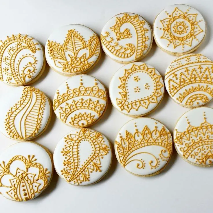 Henna-inspired mehendi cookies with white and gold royal icing paisley designs, Udaipur